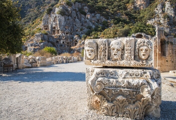Historical Stone faces bas relief at Myra ancient city. Rock-cut tombs Ruins in Lycia region,...