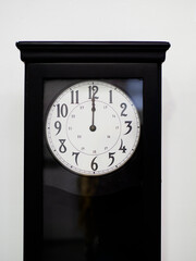 wall clock striking noon - twelve o'clock - midnight