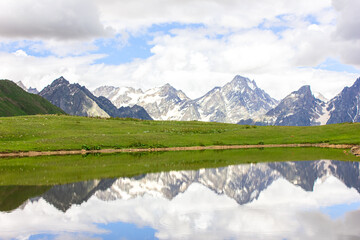 Fototapeta premium The Caucasus mountains and clouds are reflected in the mountain Koruldi lakes