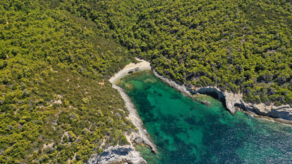 Aerial drone photo of tropical exotic paradise bay with deep turquoise sea and caves forming a blue lagoon visited by luxury yachts and sail boats