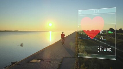Smart technology futuristic virtual personal trainer monitoring cardio activity of a man bicycling during sunset