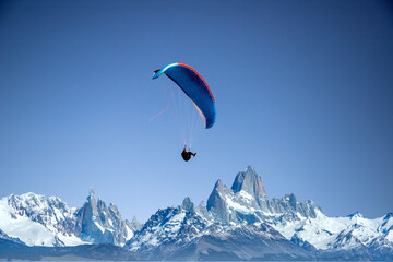 glider paragliding over snowy mountain peaks flying  adrenaline and freedom concept