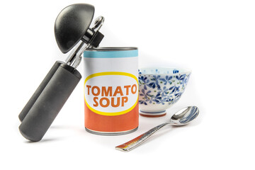 A fake generic labelled food can of tomato soup with a can opener and soup bowl isolated on white