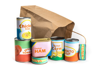 A paper grocery store shopping bag with a variety of fake generic labelled food cans isolated on...