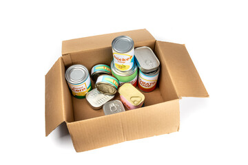 A grocery store checkout cardboard box filled with a variety of fake generic labelled food cans...