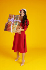 beautiful brunette girl with long hair in a red santa claus hat dress holding a little daughter in a red santa claus hat dress new Year's concept