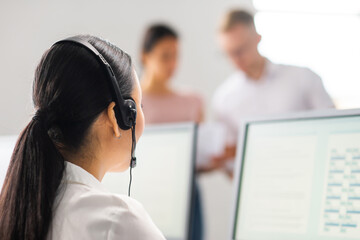 Diverse team of young professionals is working in the phone support office. Working day of sales...