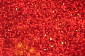 Red and golden sparkling glitter bokeh background, christmas abstract defocused texture. Holiday lights