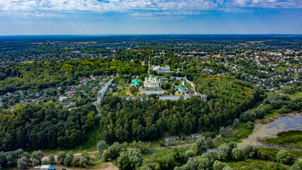 Fototapeta na wymiar Bird's eye view of an old church in a village on a beautiful summer day. Picture from above an ancient church during day time