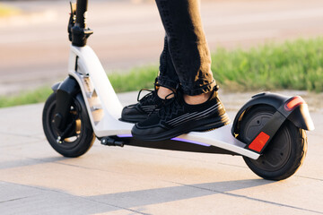 Close up - Male riding electric scooter. Modern transportation gadget and popular futuristic device...
