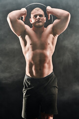 Fototapeta premium bodybuilder with iron disk