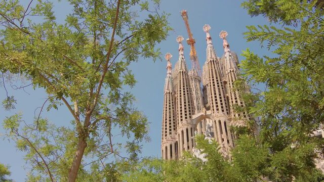 Sagrada Familia in Barcelona, Spain. Basilica, roman catholic, catalonia, summer, beautiful, blue sky, Antoni Gaudi, unesco, tourist destination / 4K Video Footage