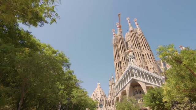 Sagrada Familia in Barcelona, Spain. Basilica, roman catholic, catalonia, summer, beautiful, blue sky, Antoni Gaudi, unesco, tourist destination / 4K Video Footage