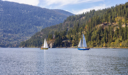 Scenic View of Kootenay River with Sailboat. Sunny Fall Season Morning. Located in Nelson, British Columbia, Canada.