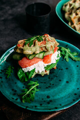 Belgian waffles with salmon, cucumber and egg in a plate