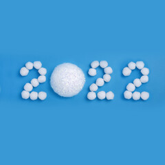 2022 New Year made from snow balls on blue background