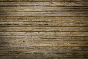 Naklejka premium Wooden logs of an old house. Close-up. Weathered natural gray wood texture. Background. Horizontal photo