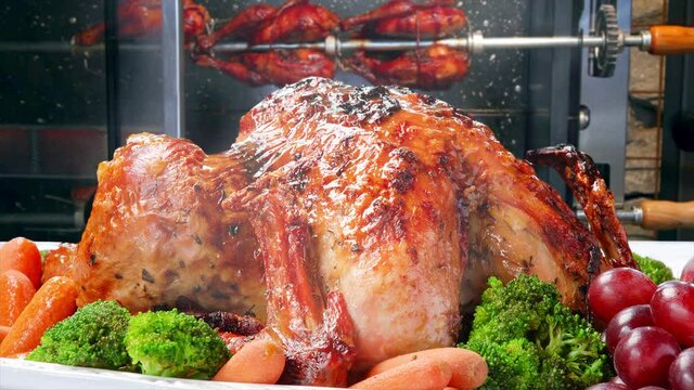 Roasted chickens in a row in a shop roaster