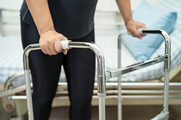 Asian lady patient pain her back, waist, leg and orthopedic lumbar with walker.