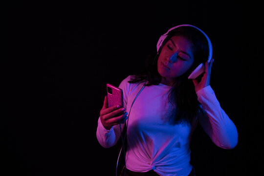 Girl listening to relaxing music with headphones