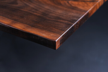 Style wooden countertop slab, saw cut wood treated with varnish close-up on black. Isolate.