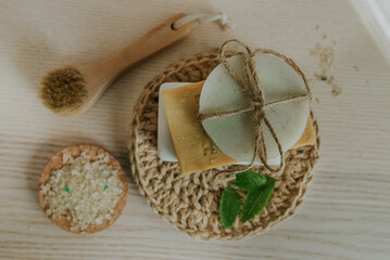 Fototapeta na wymiar Natural soap, massage brush, jute washcloth, natural sea bath salt, herbs..The concept of an environmentally friendly and waste-free lifestyle. Balance concept. Place for text