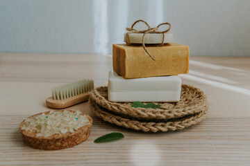 Obraz na płótnie Canvas Natural soap, massage brush, jute washcloth, natural sea bath salt, herbs..The concept of an environmentally friendly and waste-free lifestyle. Balance concept. Place for text