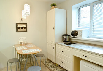 A fragment of the interior of modern kitchen in light colors