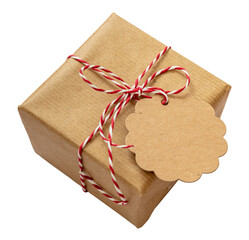 Christmas gift box with card isolated on white background. Red white twisted string on brown present