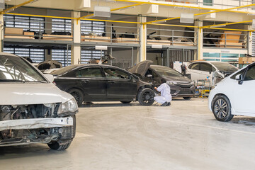 Fototapeta na wymiar Broken car in auto repair service workshop
