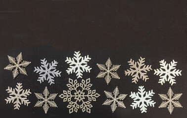 Winter season holidays, Christmas and New year. Snowflakes on black background, space, card template