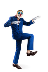 Man in a clown mask walks or sneaks. Dressed in a bright blue business suit. Isolated over white background. Hand gesture in white gloves. Halloween.