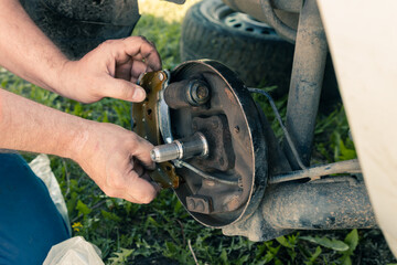 Replacing brake pads on an old car. Dismantling and repair of the brake drum.