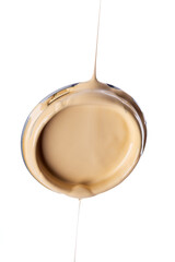 Lid of can with paint dripping isolated on white background