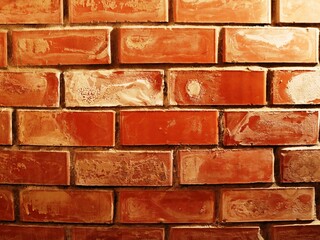 bright brick wall surface with traces of whitewash, textured background of orange brickwork with...