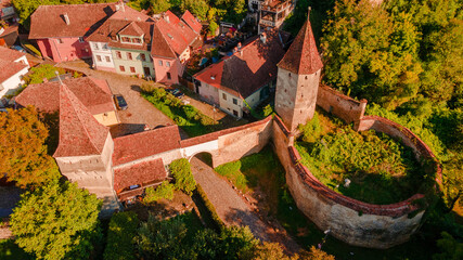 Aerial photography of a fortified gate with towers at medieval town of Sighisoara located in...