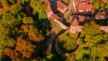 Aerial photography of a fortified gate with towers at medieval town of Sighisoara located in...