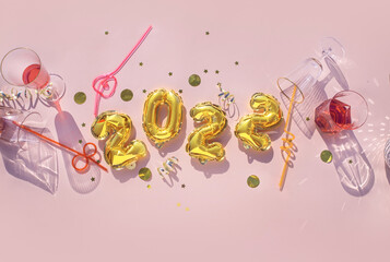 Gold balloons 2022, champagne glasses Concept fun New Years party