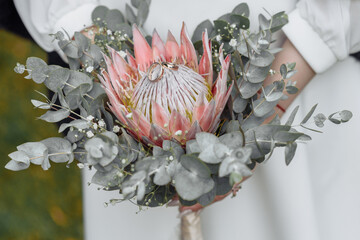 Protea flower in the wedding bouquet, beautiful wedding bouquet of protea flowers in hands of the...