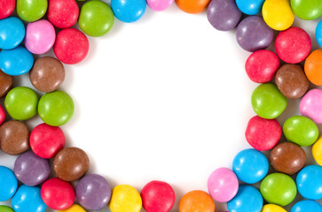 Frame of colored background of assorted candies balls
