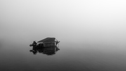 sloop on the lake at morning fog