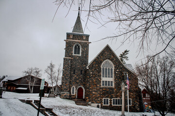 City of Lake Placid, New York, United States - November 28, 2019: Adirondack Community Church, an ancient church on a snowy day in Winter. 