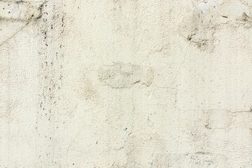 The surface of the old light concrete wall with cracks. Abstract background, texture. Close-up.