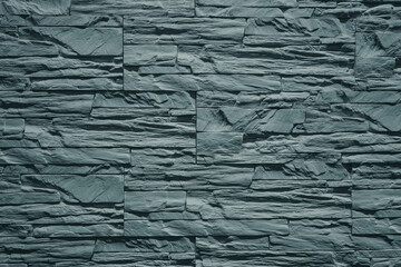 Photo of a wall in gray stone brick