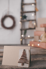 Close up creative sustainable eco Christmas tree handmade of wooden branches on the background gift boxes. Zero waste Christmas concept. High quality photo