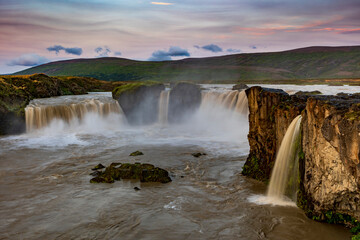 dramatic sky during sunset in the powerful Godafoss waterfall in Iceland.