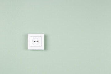 White electric socket on yellow background. One electrical outlet on the wall