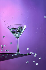 Glass of martini with ice on a gradient background, creative photo of a drink on a colored background