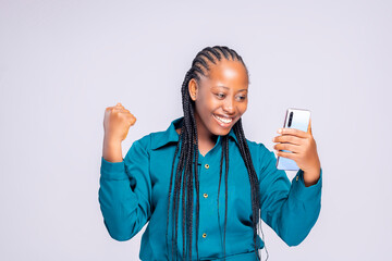 black african lady using cell phone standing on a white background 