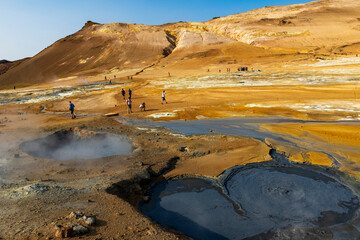 surreal landscape in   geothermal area near Lake Myvatn, Iceland.  Hverir is characterized by boiling mud pots and fumaroles that steam. 